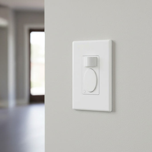 A modern white light switch with a rectangular motion sensor window is mounted on a painted grey wall near a doorway.